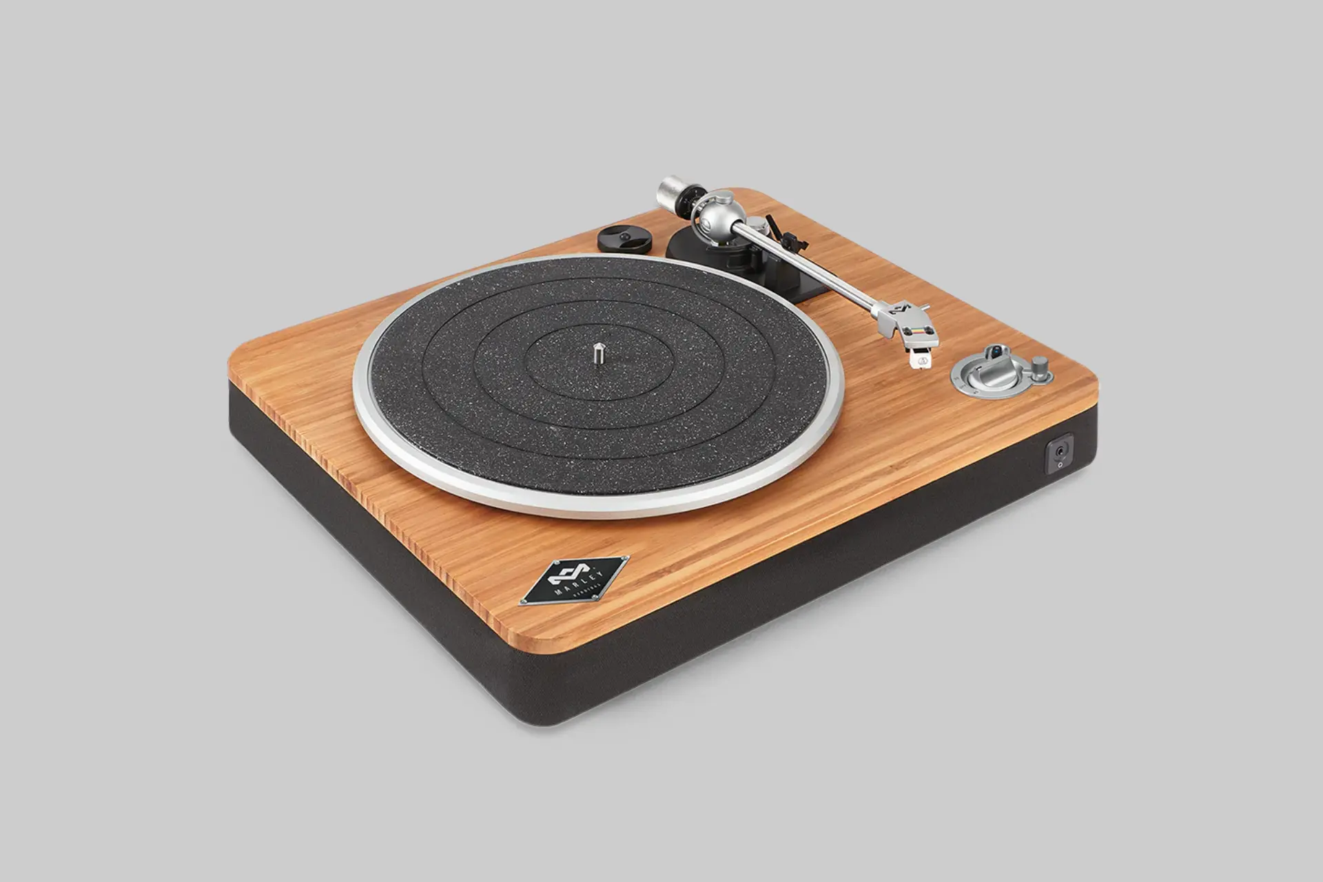 House of Marley Stir It Up Wireless Turntable, featuring a bamboo plinth and an aluminum platter, playing a vinyl record. - Product Review