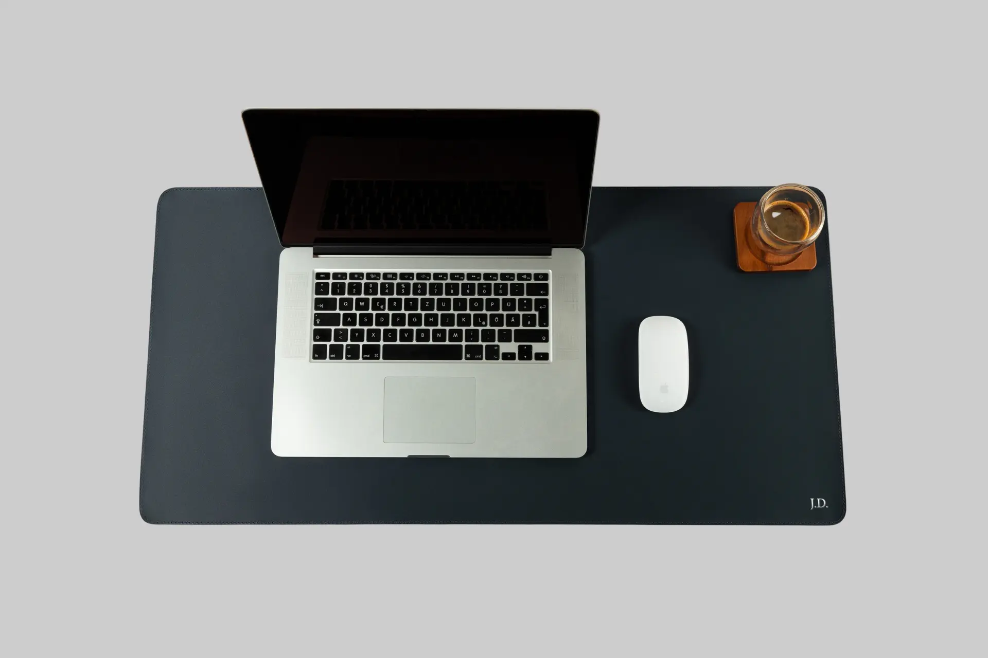 Close-up of a St. George Leather Desk Mat in black, showcasing the smooth full-grain leather texture and clean stitching on a minimalist desk setup. - Product Review